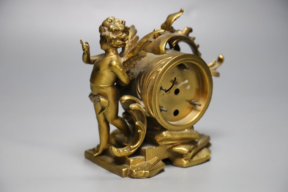 An American ormolu timepiece, New Haven Clock Co., movement in rococo style case with cherub surmount, 16cm high